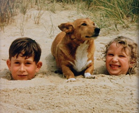 Prince Charles and Princess Anne in the sand with 