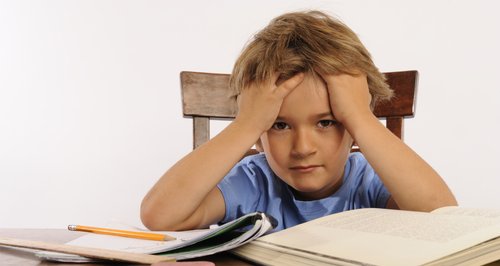 Confused boy head in hands