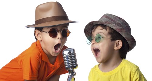 Kids singing karaoke dressed up in fancy dress