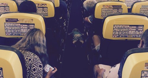 Little boy falls asleep face down in the aisle of