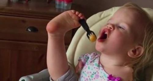Baby girl with no arms feeding herself